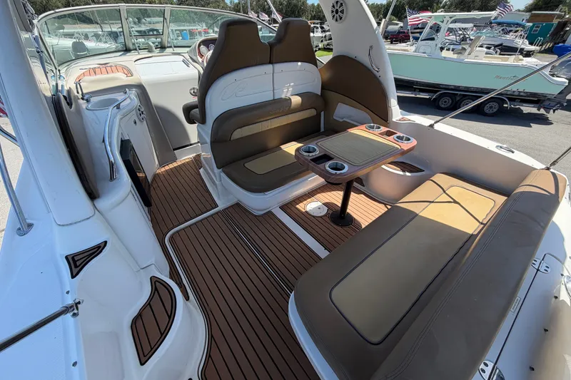 Slide: The Image of 2006 Sea Ray 300 Sundancer boat interior with seating and table, docked at marina. - 18