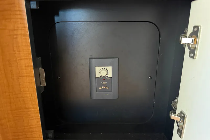 Slide: The Image of Safe inside a cabinet on a 2006 Sea Ray 300 Sundancer boat. - 74