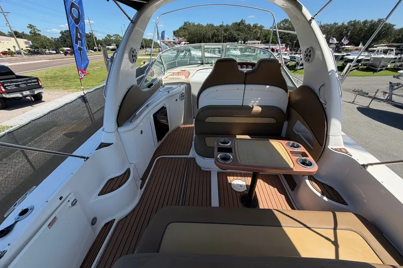 Slide: The Image of 2006 Sea Ray 300 Sundancer boat interior with seating and table, showcasing luxury design. - 17