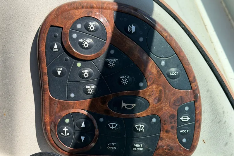 Slide: The Image of Control panel of a 2006 Sea Ray 300 Sundancer boat with various function buttons. - 34