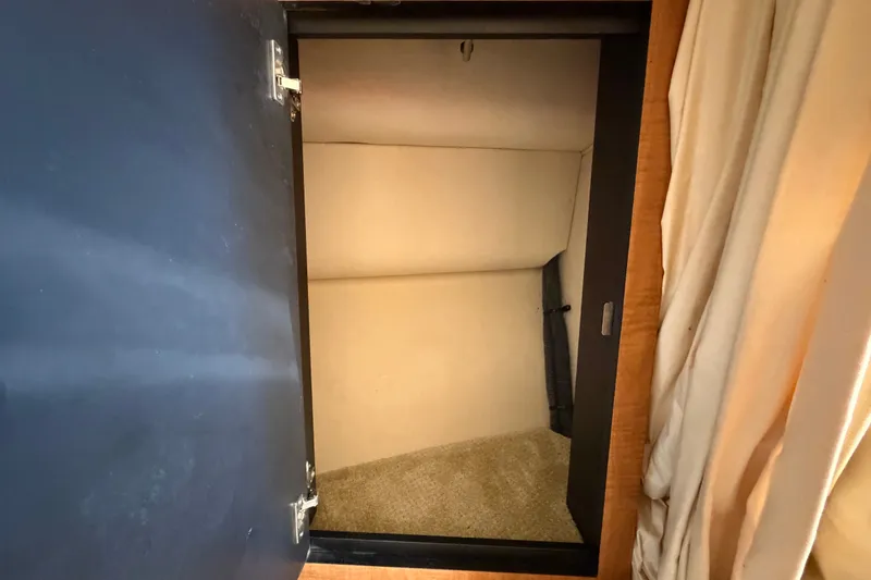 Slide: The Image of Open storage compartment inside 2006 Sea Ray 300 Sundancer boat. - 81