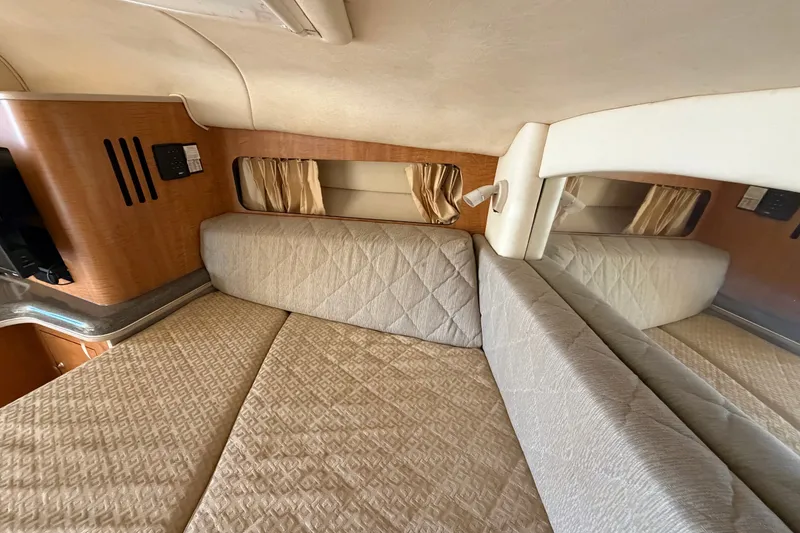 Slide: The Image of Interior cabin of 2006 Sea Ray 300 Sundancer with beige upholstery and wood accents. - 82
