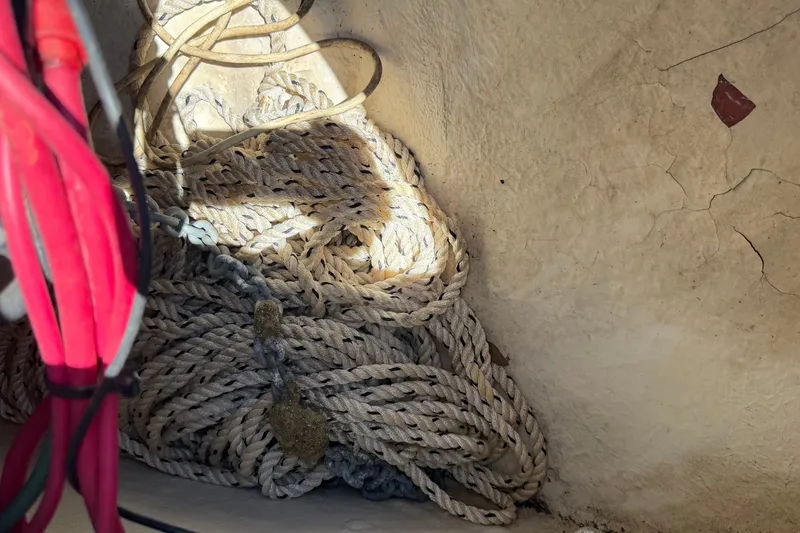 Slide: The Image of A bundle of ropes is lying in a corner of the boat. - 49