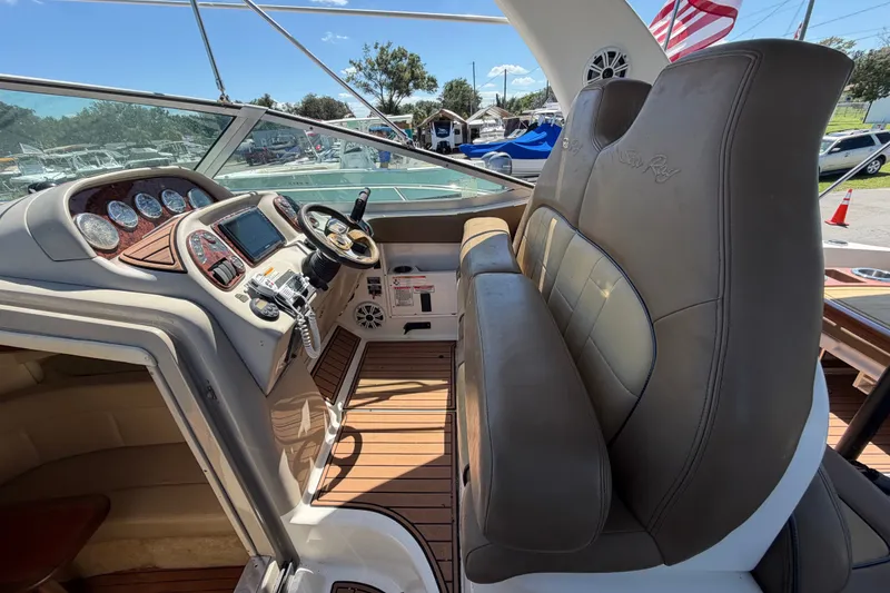 Slide: The Image of 2006 Sea Ray 300 Sundancer cockpit with leather seats and modern dashboard controls. - 42