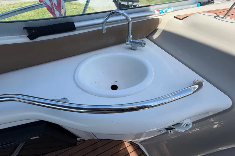 Slide: The Image of 2006 Sea Ray 300 Sundancer boat sink with chrome faucet and railing. - 26