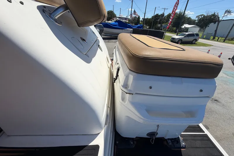 Slide: The Image of 2006 Sea Ray 300 Sundancer boat with cushioned seating, docked outdoors. - 114