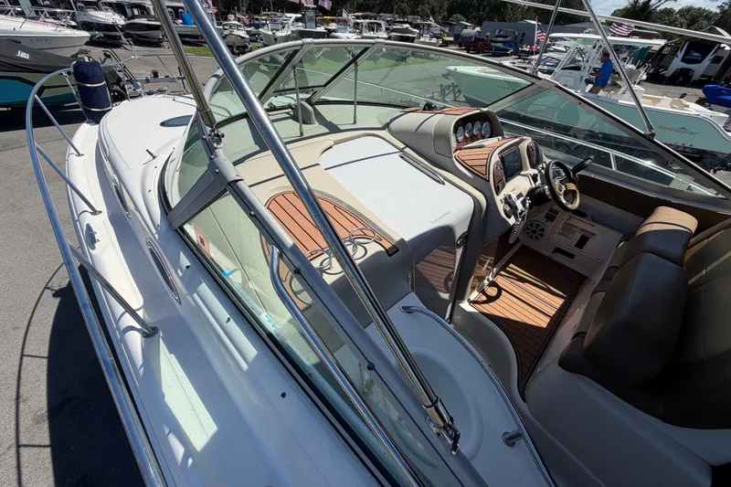 Slide: The Image of 2006 Sea Ray 300 Sundancer boat interior with helm and seating area. - 44
