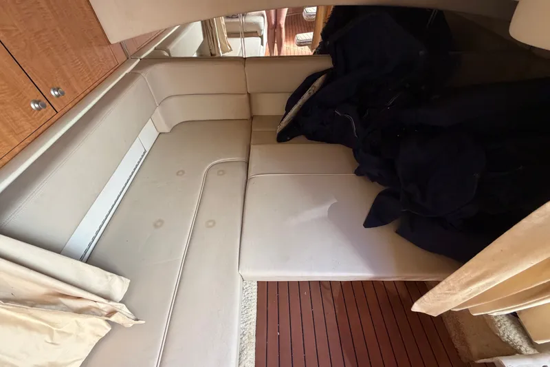Slide: The Image of Interior cabin of 2006 Sea Ray 300 Sundancer with beige seating and wooden flooring. - 98