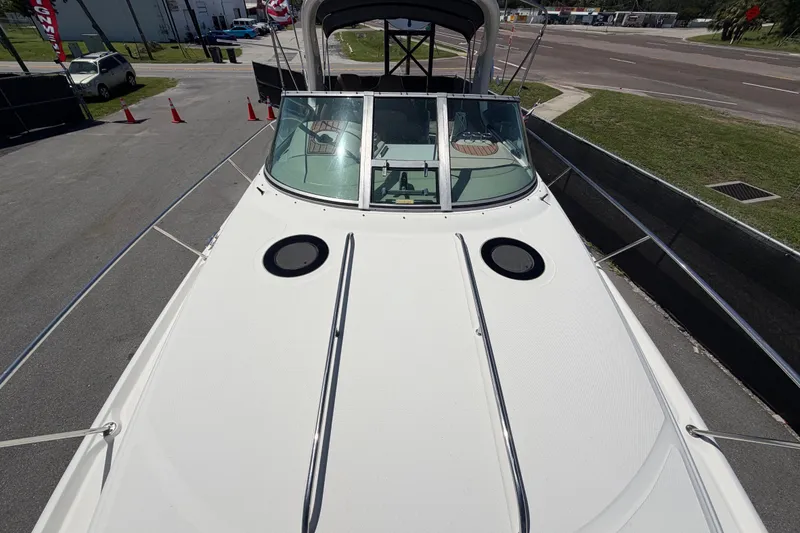 Slide: The Image of 2006 Sea Ray 300 Sundancer boat, top view, docked on a sunny day. - 52