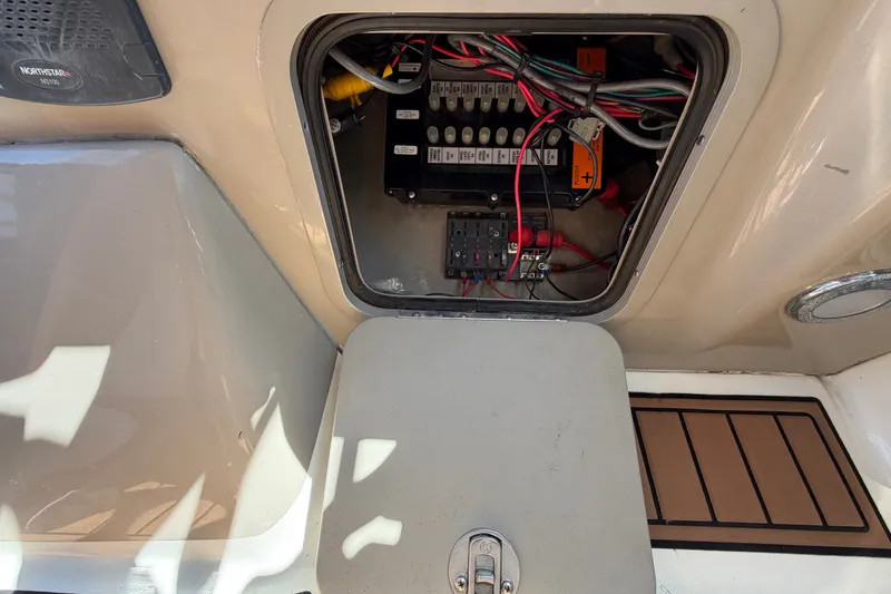 Slide: The Image of Electrical panel inside a 2006 Sea Ray 300 Sundancer boat, showing wiring and components. - 41
