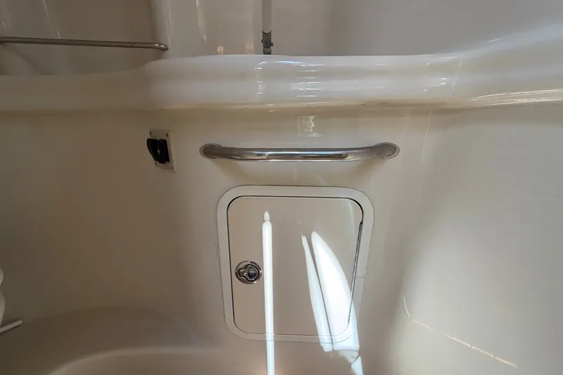 Slide: The Image of 2006 Sea Ray 300 Sundancer interior detail with storage compartment and handle. - 63