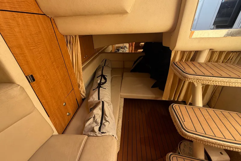 Slide: The Image of Interior of 2006 Sea Ray 300 Sundancer with wood accents and seating area. - 91