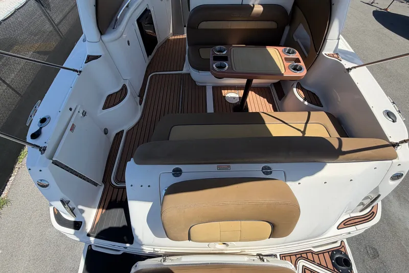 Slide: The Image of 2006 Sea Ray 300 Sundancer boat interior with seating and table, featuring wood accents. - 16