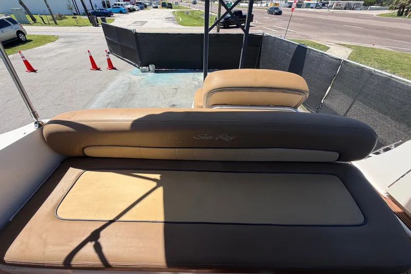 Slide: The Image of 2006 Sea Ray 300 Sundancer boat seating area with tan upholstery. - 111