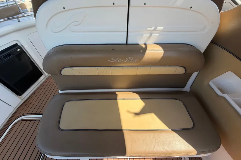 Slide: The Image of 2006 Sea Ray 300 Sundancer boat interior with tan seating and wood flooring. - 20