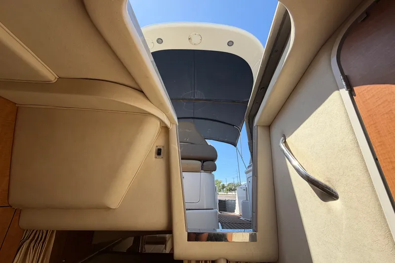 Slide: The Image of Interior view of 2006 Sea Ray 300 Sundancer yacht, showcasing cabin entrance and seating. - 104