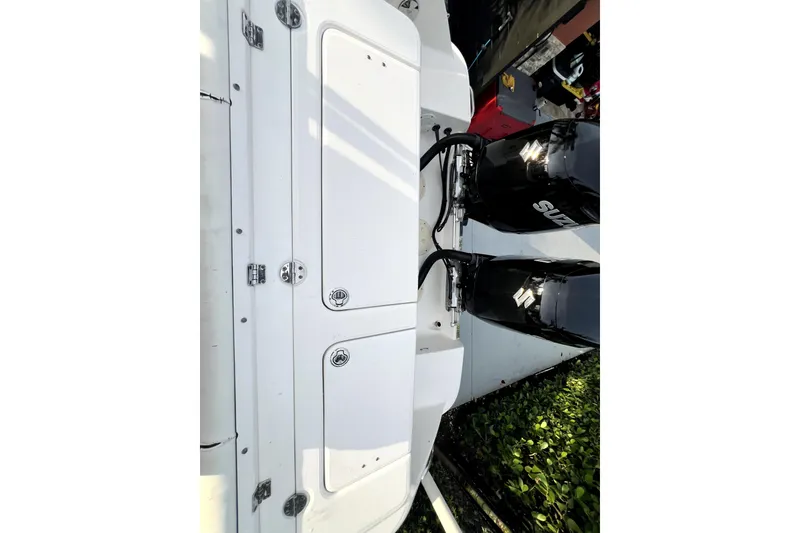 Slide: The Image of 2014 Robalo R265 Walkaround boat with dual Suzuki outboard engines. - 101