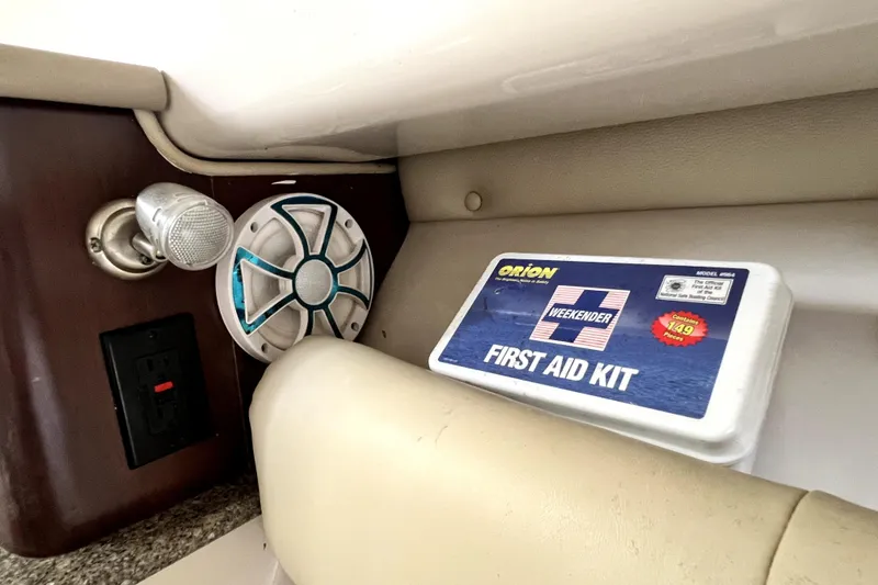 Slide: The Image of 2014 Robalo R265 Walkaround interior with first aid kit and speaker. - 118
