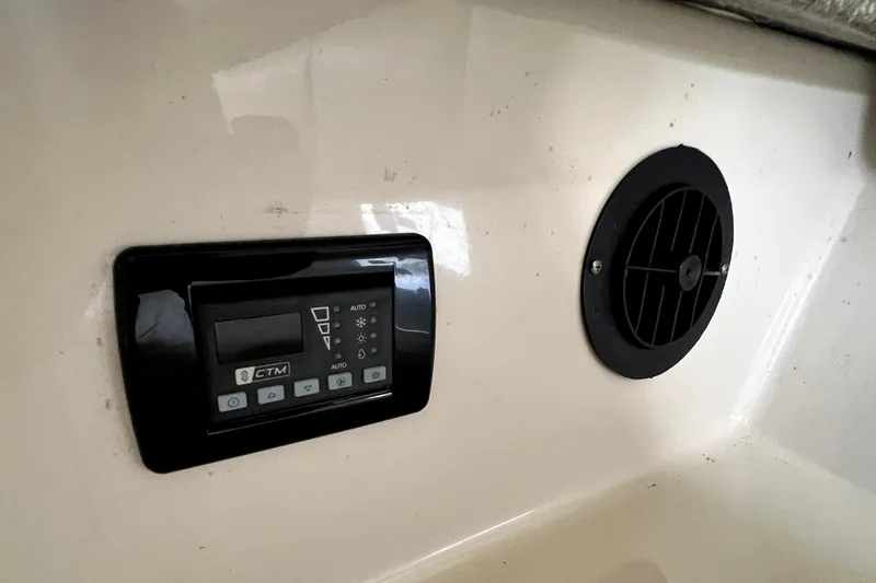 Slide: The Image of Control panel and vent inside 2014 Robalo R265 Walkaround boat cabin. - 119
