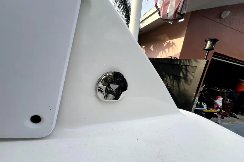 Slide: The Image of 2014 Robalo R265 Walkaround boat detail with chrome fitting, outdoor setting. - 88