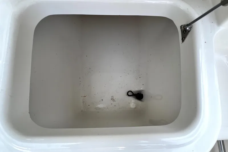 Slide: The Image of Livewell compartment in 2014 Robalo R265 Walkaround boat, featuring a clean, white interior. - 98