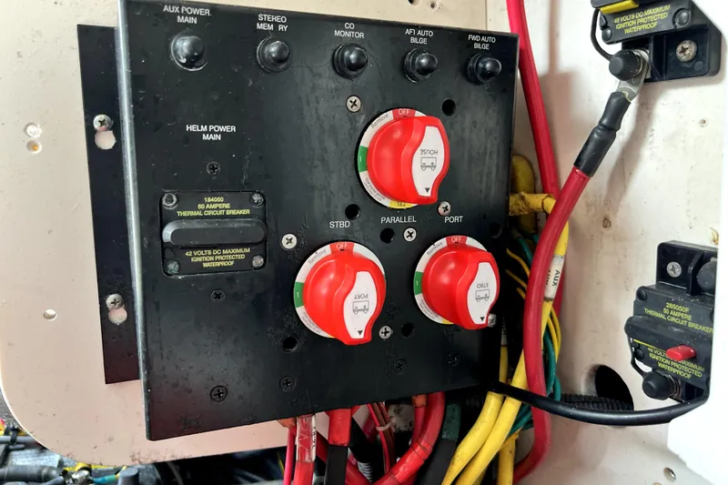 Slide: The Image of Electrical panel of a 2014 Robalo R265 Walkaround boat with circuit breakers and switches. - 103