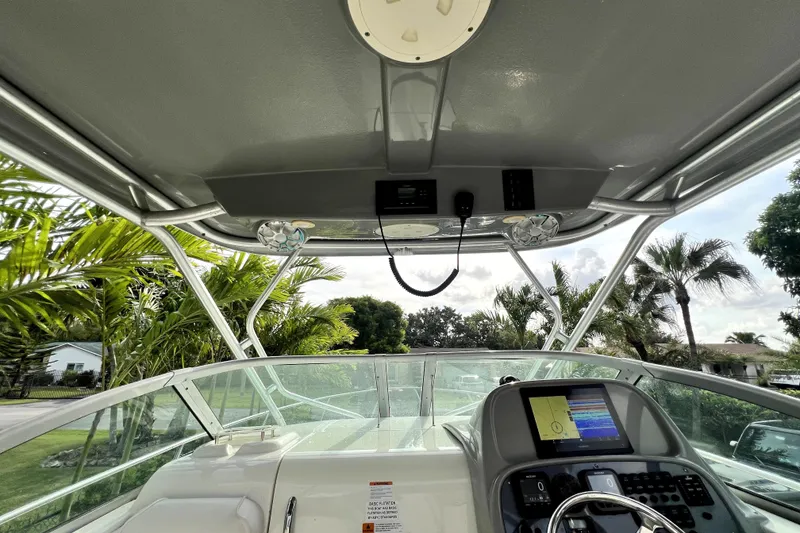 Slide: The Image of 2014 Robalo R265 Walkaround boat cockpit with steering wheel and navigation system. - 79
