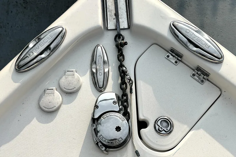 Slide: The Image of 2014 Robalo R265 Walkaround boat deck with anchor chain and chrome fittings. - 94