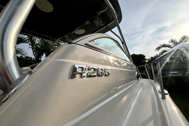 Slide: The Image of 2014 Robalo R265 Walkaround boat with sleek design and chrome detailing. - 100