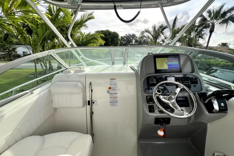 Slide: The Image of 2014 Robalo R265 Walkaround helm with modern controls and navigation system. - 80