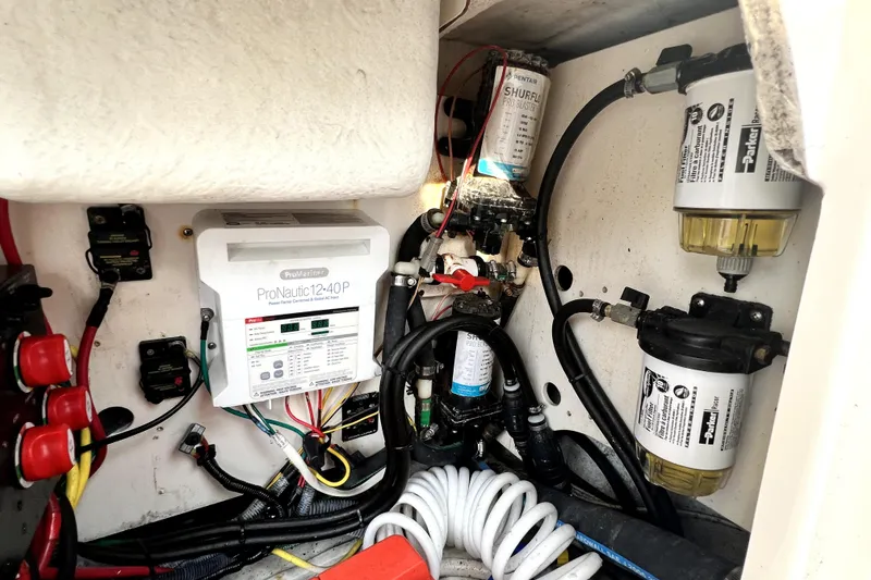 Slide: The Image of 2014 Robalo R265 Walkaround boat electrical and plumbing system components. - 95