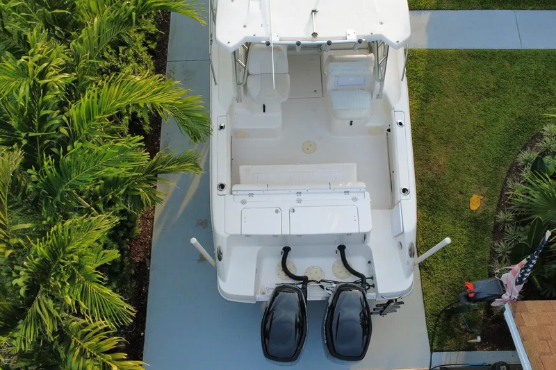 Slide: The Image of Overhead view of a 2014 Robalo R265 Walkaround boat on a driveway. - 25
