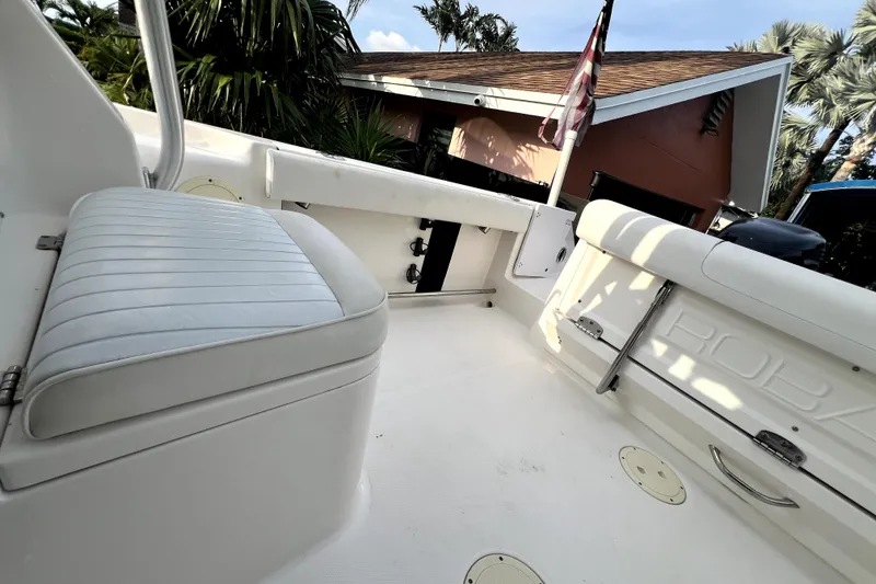 Slide: The Image of 2014 Robalo R265 Walkaround boat interior with seating and storage compartments. - 110