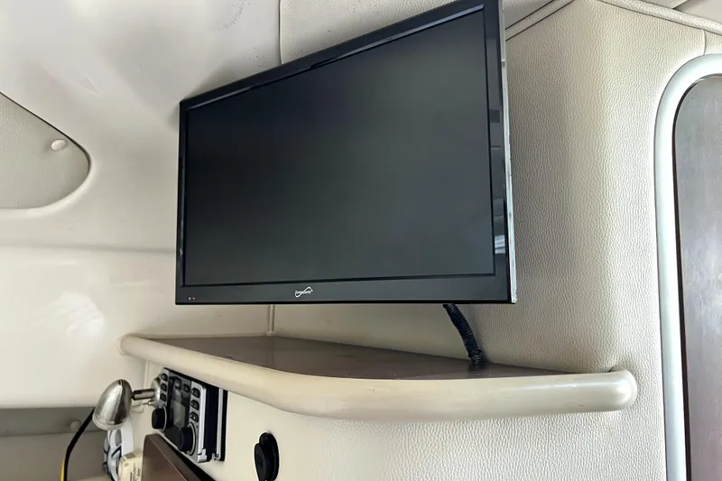 Slide: The Image of Flat-screen TV mounted inside 2014 Robalo R265 Walkaround boat cabin. - 76