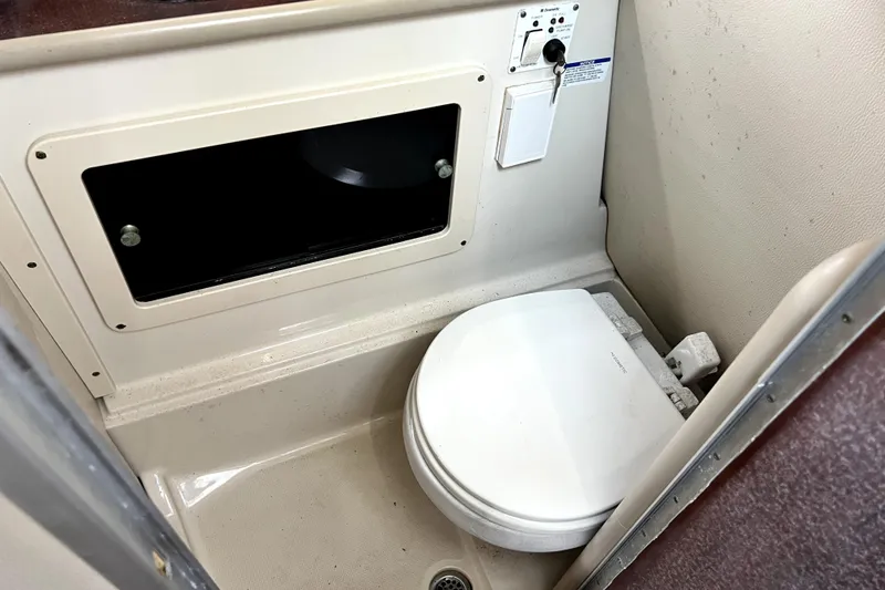 Slide: The Image of 2014 Robalo R265 Walkaround boat interior with compact marine toilet. - 74