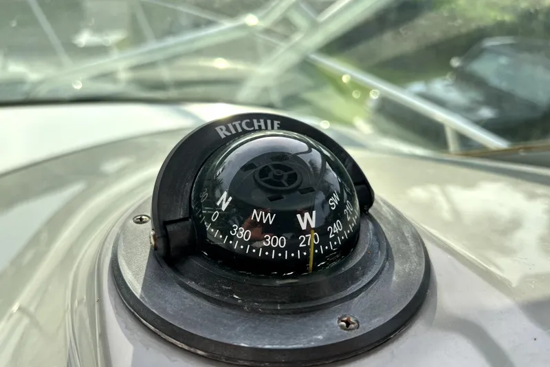 Slide: The Image of Ritchie compass on 2014 Robalo R265 Walkaround boat dashboard, showing west direction. - 113