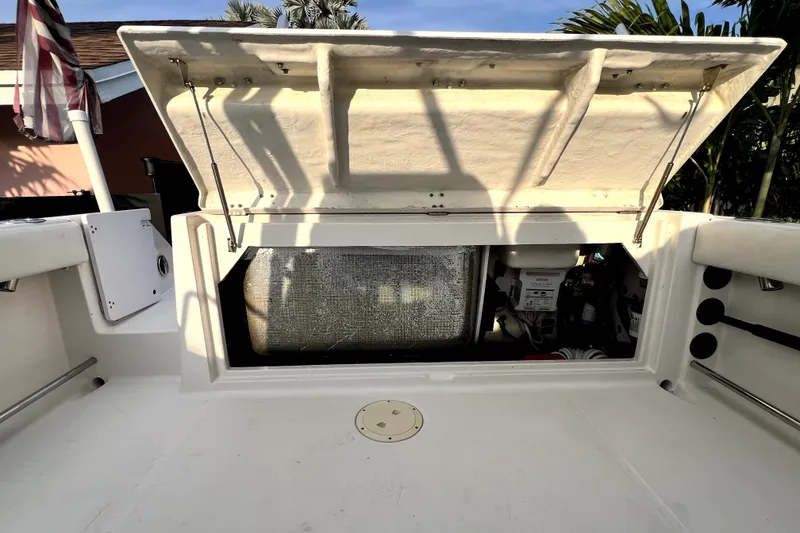 Slide: The Image of Open storage compartment on a 2014 Robalo R265 Walkaround boat. - 96