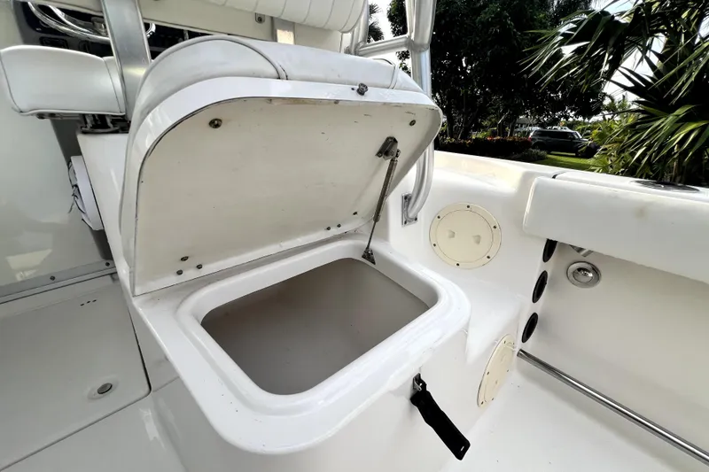 Slide: The Image of 2014 Robalo R265 Walkaround boat storage compartment open, showcasing interior space. - 105