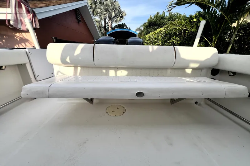 Slide: The Image of 2014 Robalo R265 Walkaround boat interior with white seating and outdoor setting. - 102