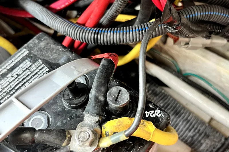 Slide: The Image of Close-up of 2014 Robalo R265 Walkaround boat battery with connected cables. - 104
