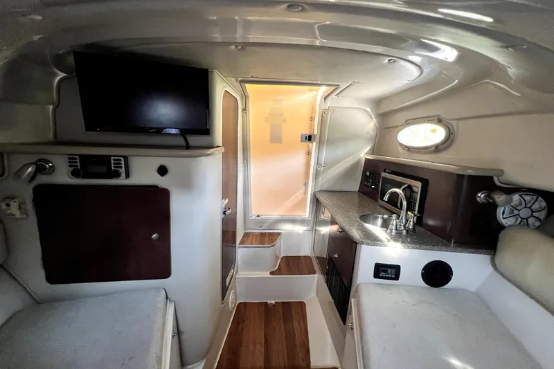 Slide: The Image of Interior of 2014 Robalo R265 Walkaround boat with kitchenette and seating area. - 121