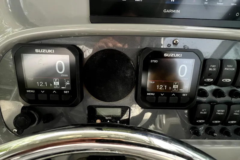 Slide: The Image of Dashboard of 2014 Robalo R265 Walkaround with Suzuki displays and Garmin navigation. - 130