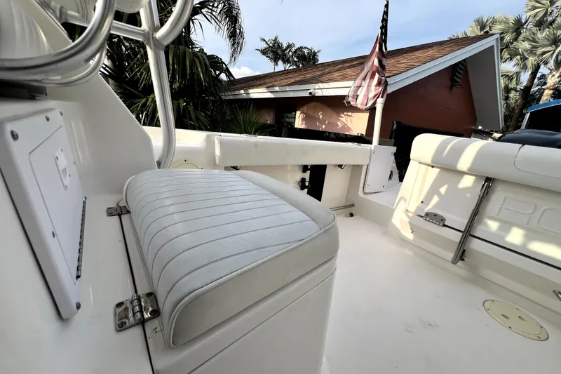 Slide: The Image of 2014 Robalo R265 Walkaround boat interior with seating and American flag. - 109