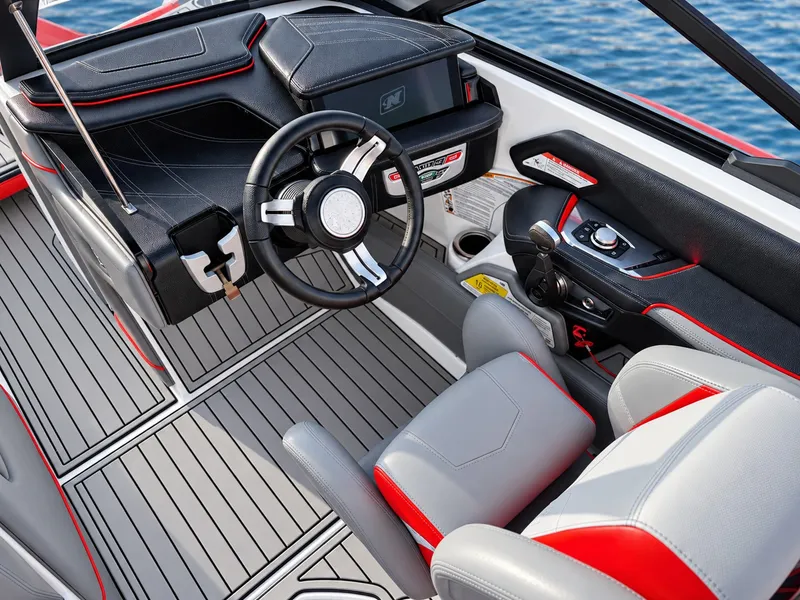 Slide: The Image of The cockpit of a 2019 Nautique Super Air Nautique G23 with gray and red accents. - 7