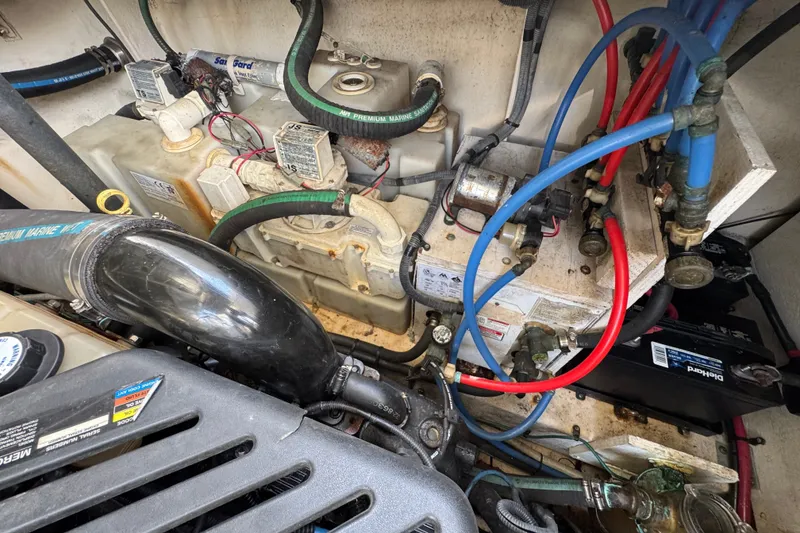 Slide: The Image of Engine compartment of a 2006 Sea Ray 340 Sundancer with visible hoses and components. - 106