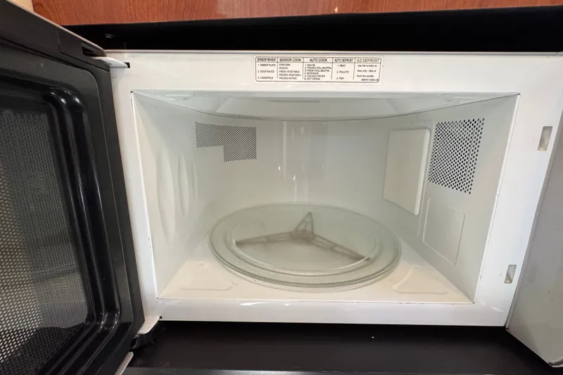 Slide: The Image of Open microwave oven inside a 2006 Sea Ray 340 Sundancer yacht. - 85