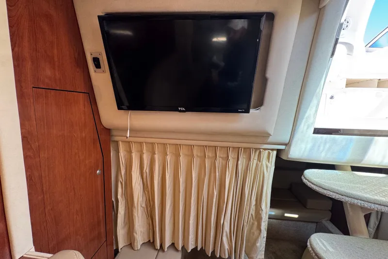 Slide: The Image of Interior of 2006 Sea Ray 340 Sundancer with TV and wooden cabinetry. - 77