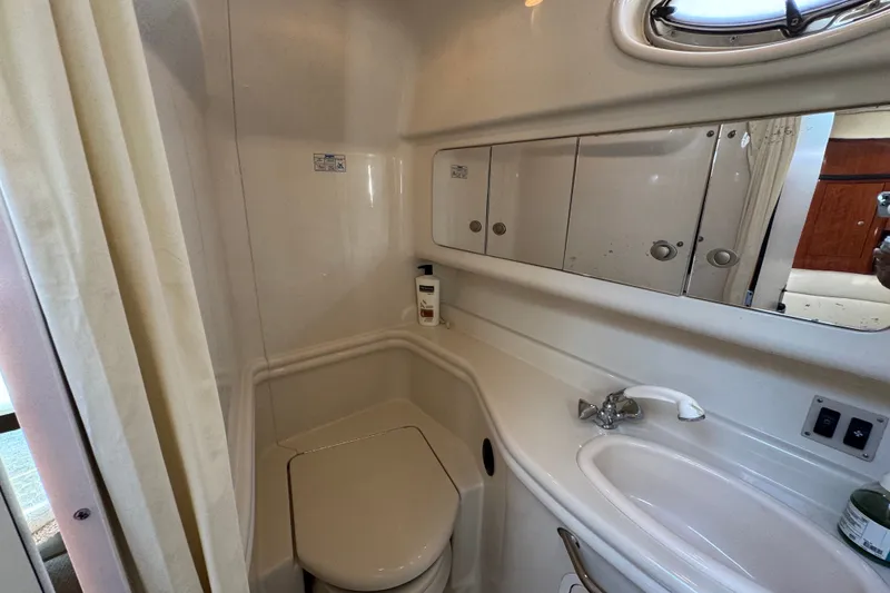 Slide: The Image of Bathroom interior of 2006 Sea Ray 340 Sundancer yacht, featuring sink and toilet. - 80