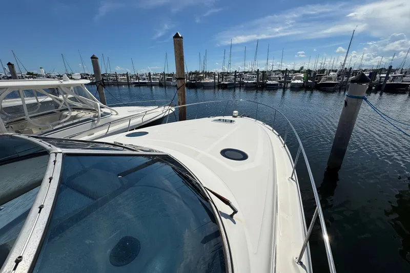 Slide: The Image of 2006 Sea Ray 340 Sundancer docked at a marina under a clear blue sky. - 49