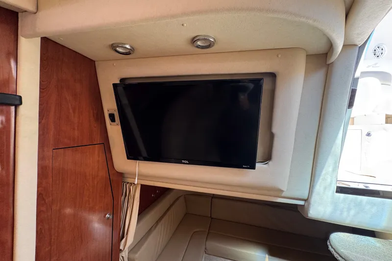 Slide: The Image of Interior of 2006 Sea Ray 340 Sundancer with mounted TV and wood paneling. - 68